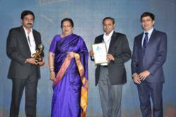 Unni Vasudev (holding award) and Dr. Amit Shekhar (holding plaque) accept the award on behalf of Corbus, LLC